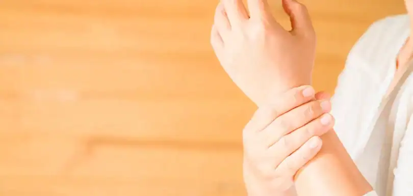 Person holding wrist pain area, demonstrating arthritis discomfort.