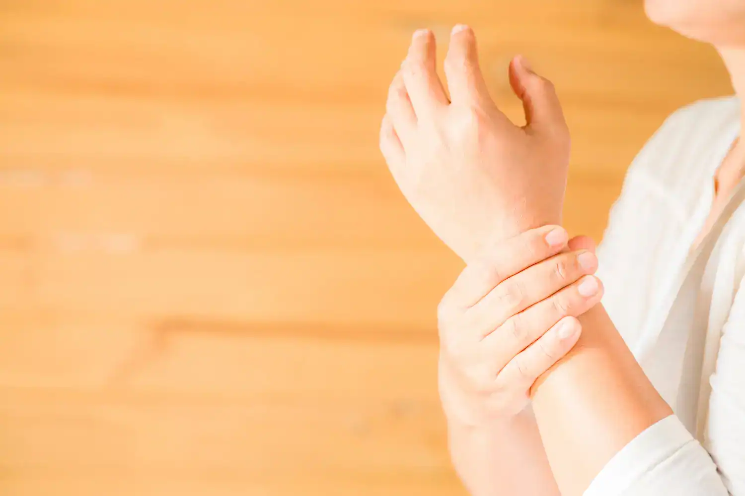 Person holding wrist pain area, demonstrating arthritis discomfort.