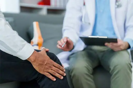 Pain doctor helping patient with knee pain